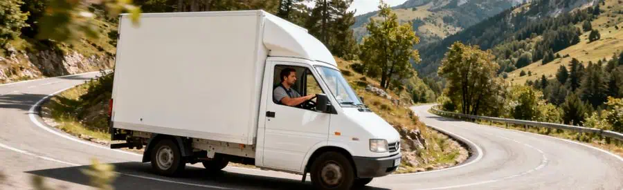 Camion déménagement compact négociant virage serré route montagne Lozère, relief accidenté